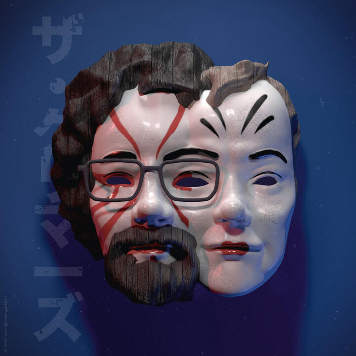 De afbeelding toont een houten masker met rode lijnen op het gezicht, gekruld haar en een bril, tegen een donkere blauwe achtergrond met kleine witte stippen. Er staat Japanse tekst aan de linkerkant: "ザ・ゲームズ."